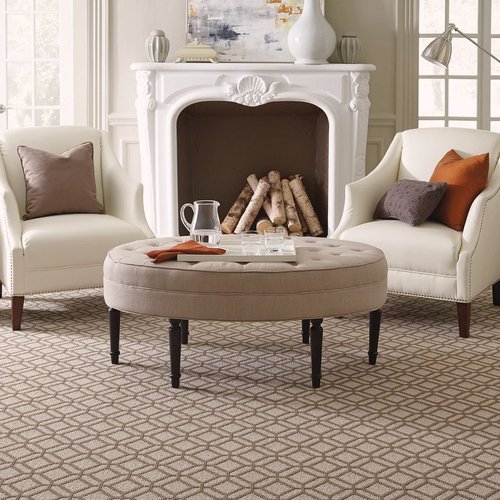 Living room with fireplace and 2 armchairs on brown patterned carpet from Excel Carpet LTD in the Commack, NY area