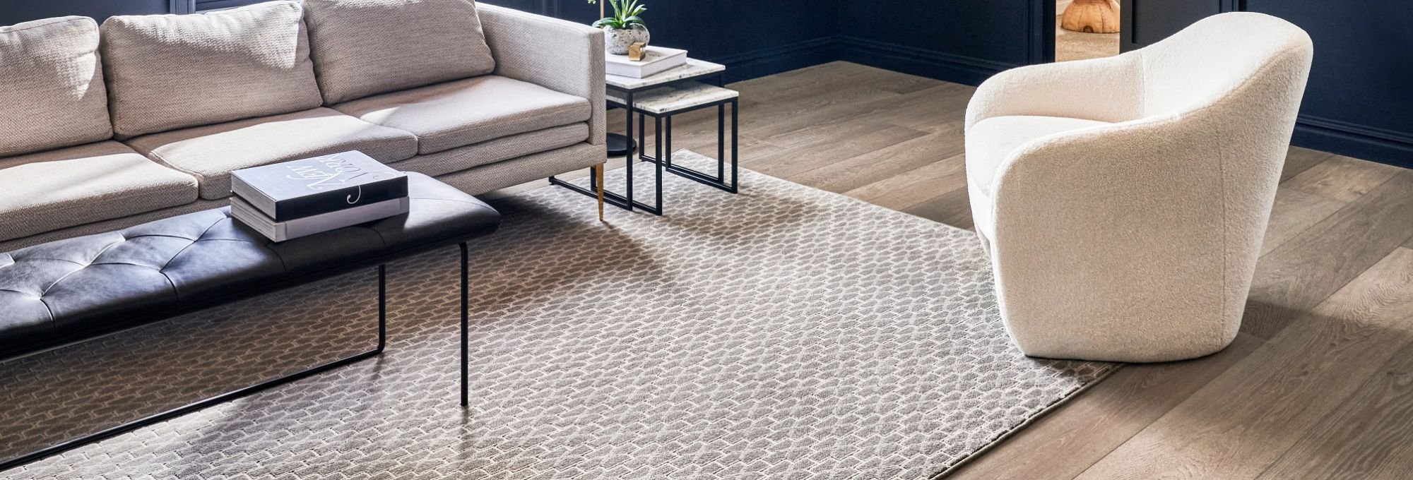 Living room with hardwood floor and large area rug from Excel Carpet LTD in the Commack, NY area