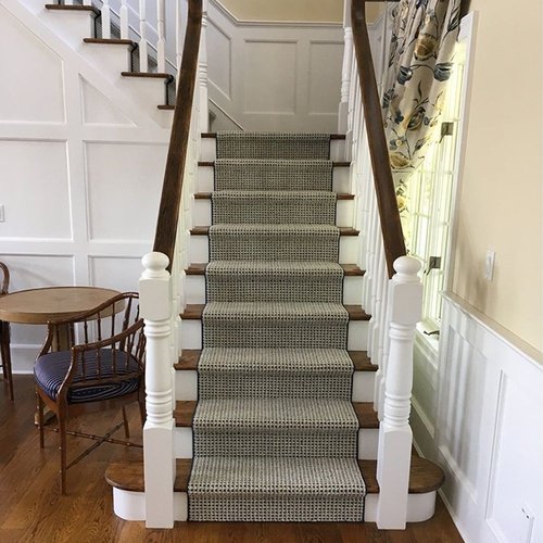 staircase with green carpet in room with hardwood flooring from Excel Carpet LTD in the Commack, NY area